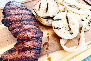 grilled London Broil on a cutting board